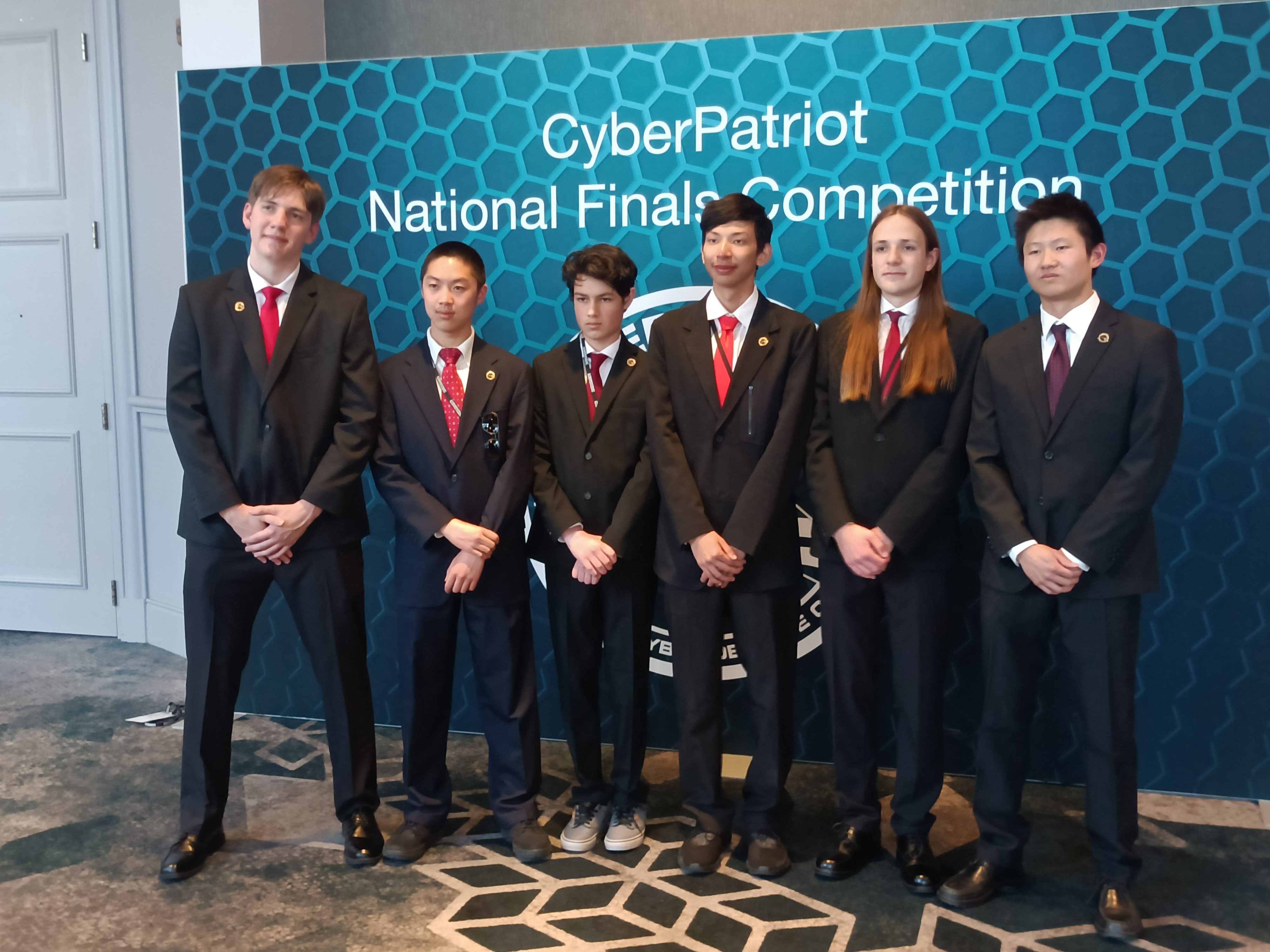 Team photo at the CyberPatriot banner